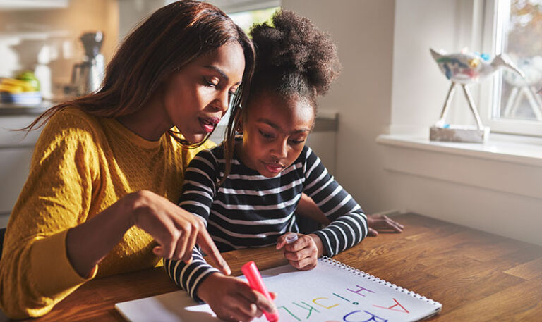 A parent guiding a child through a learning activity
